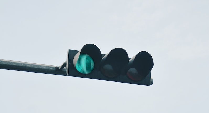 a traffic light that is green on a pole